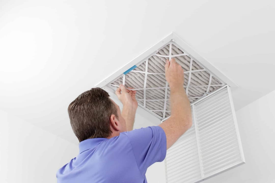man replacing air filter