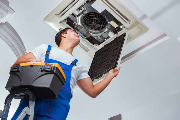 Worker repairing ac unit