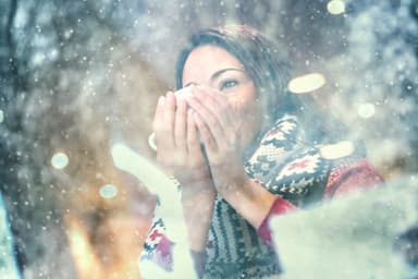 Woman having a tea or coffee on snowy day