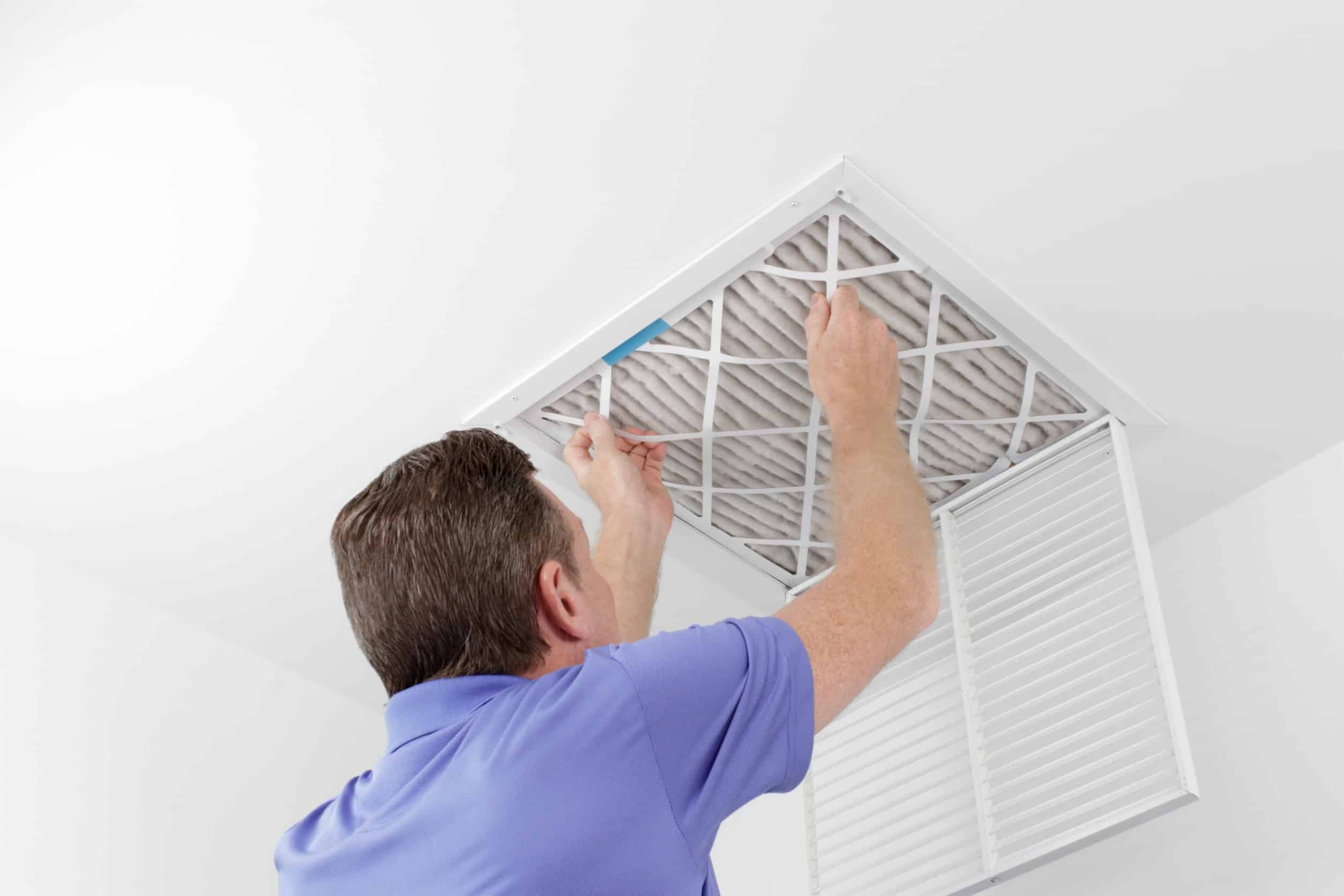 man replacing air filter