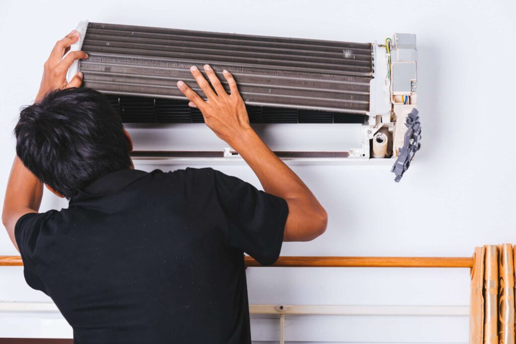 HVAC technician repairing air conditioner